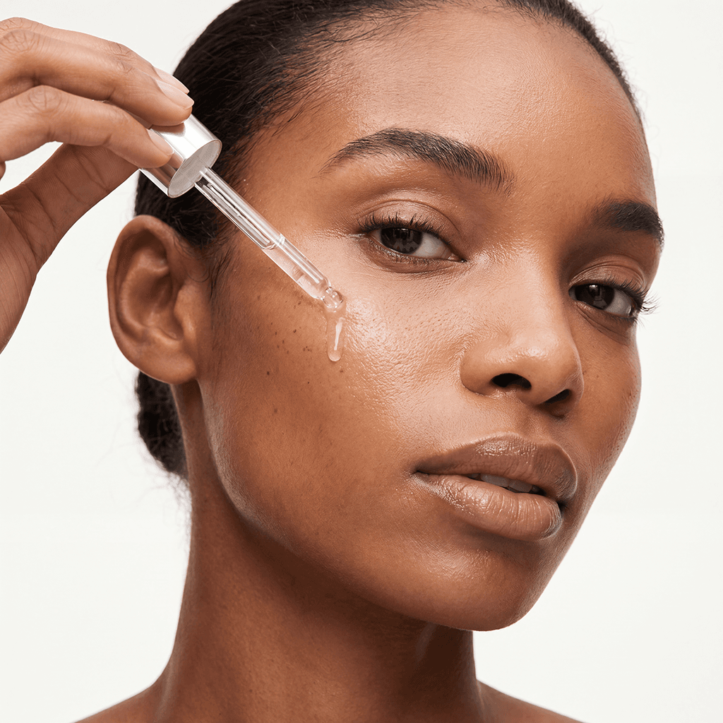 A skincare close-up: serum applied to the face, skin and lighting held true